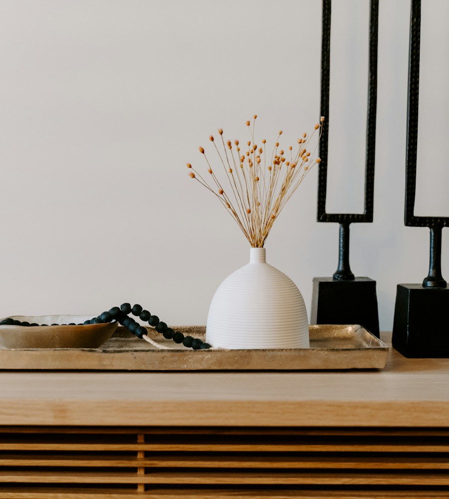 Console table styled with a ceramic vase and decorative objects