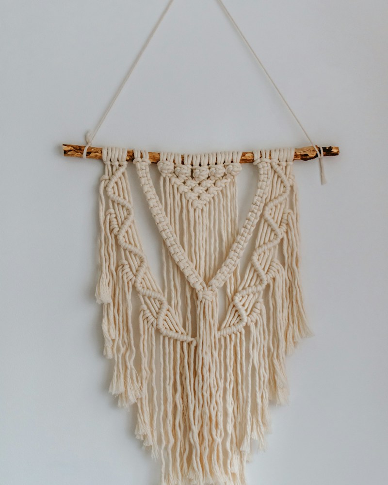 Natural cotton macramé wall hanging on a white wall