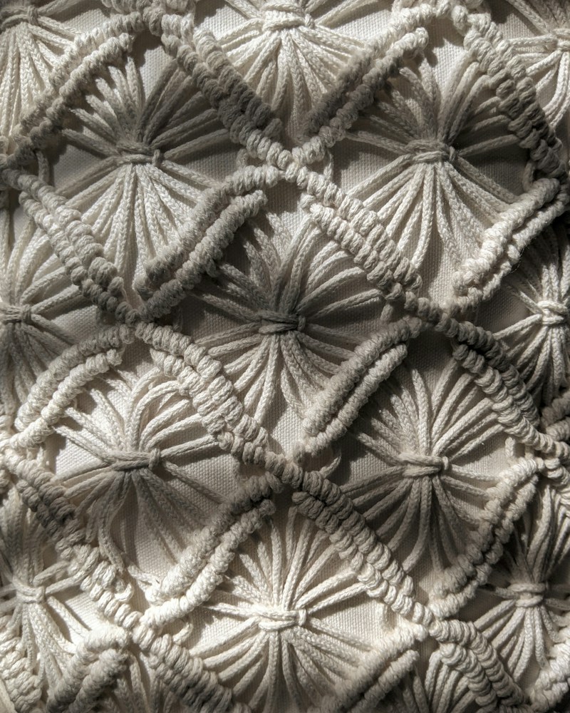 Close-up of woven cotton textile with natural and earth-tone threads